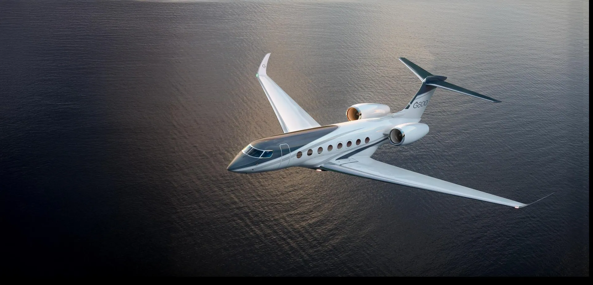A long-range private jet turning over open ocean on a global charter